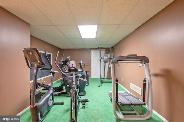 workout room with carpet and a paneled ceiling