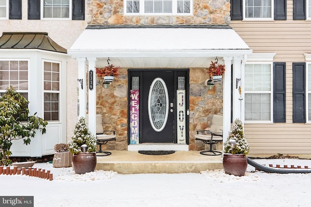 view of snow covered property entrance