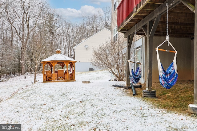 yard covered in snow featuring a gazebo