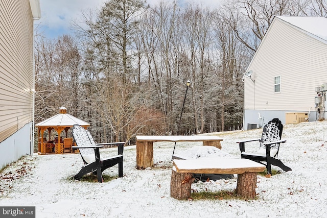 yard covered in snow with a gazebo and cooling unit