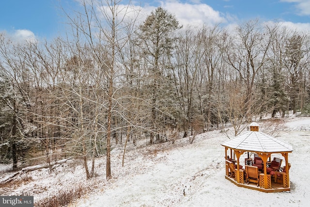 yard layered in snow featuring a gazebo