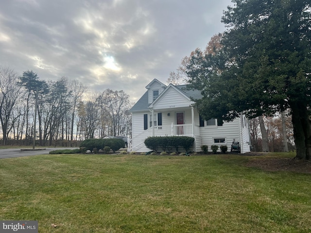 view of front of home featuring a front yard and a porch