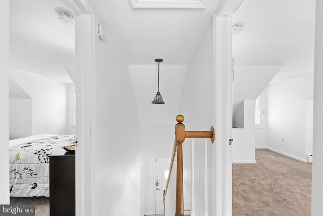 hallway featuring carpet floors and vaulted ceiling