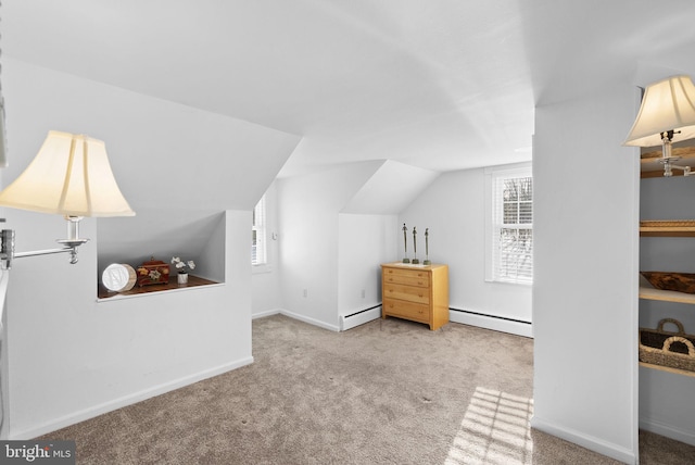 additional living space featuring carpet, lofted ceiling, and a baseboard heating unit