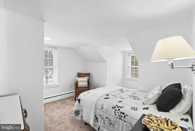 bedroom with baseboard heating, carpet flooring, and lofted ceiling