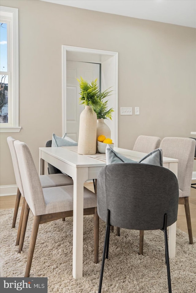 dining space with light wood-type flooring