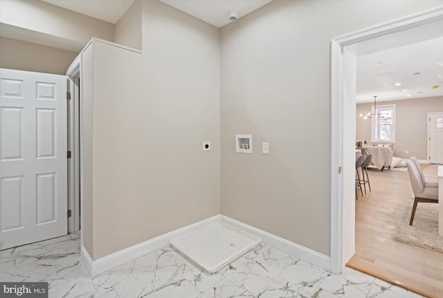 laundry area featuring hookup for a washing machine, hookup for an electric dryer, and an inviting chandelier