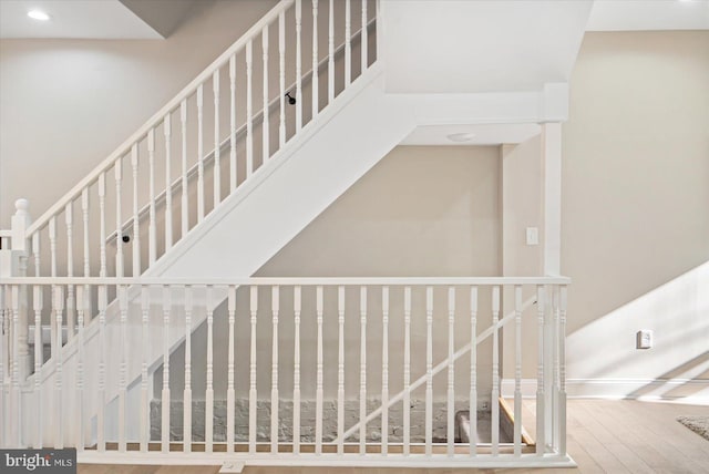 stairs featuring hardwood / wood-style floors