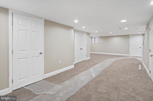 basement featuring light carpet