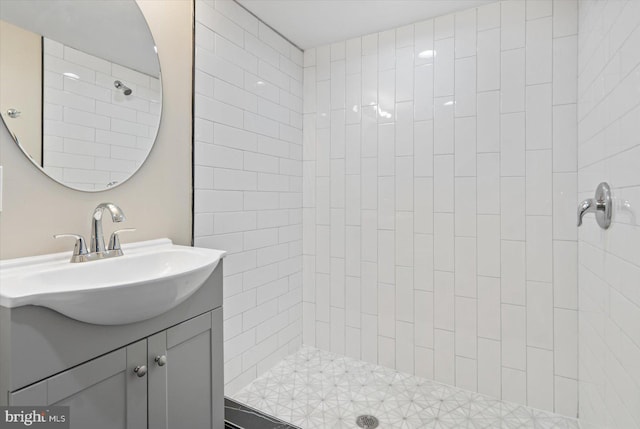 bathroom with vanity and a tile shower