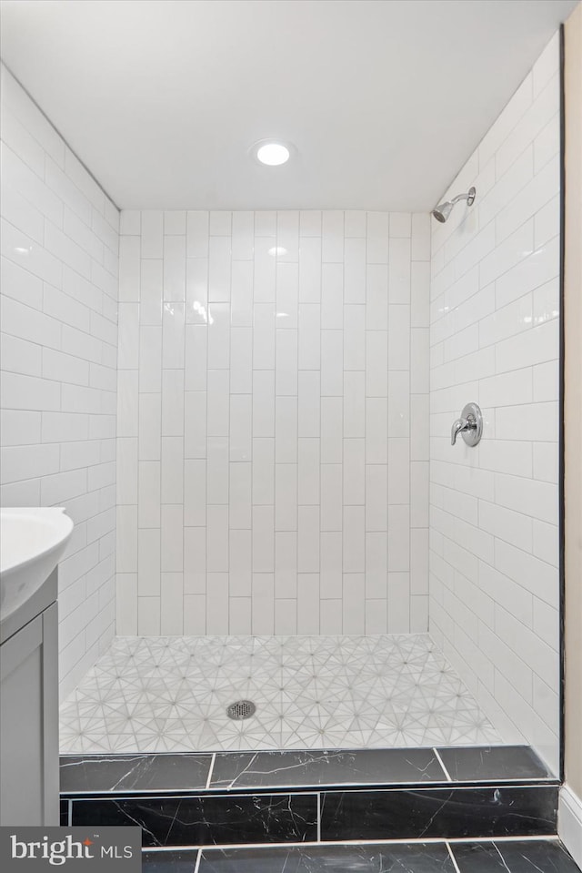 bathroom featuring vanity and a tile shower