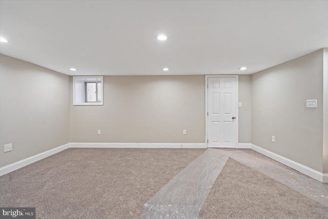 basement featuring light carpet