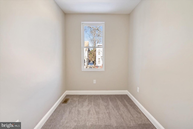 unfurnished room featuring light carpet