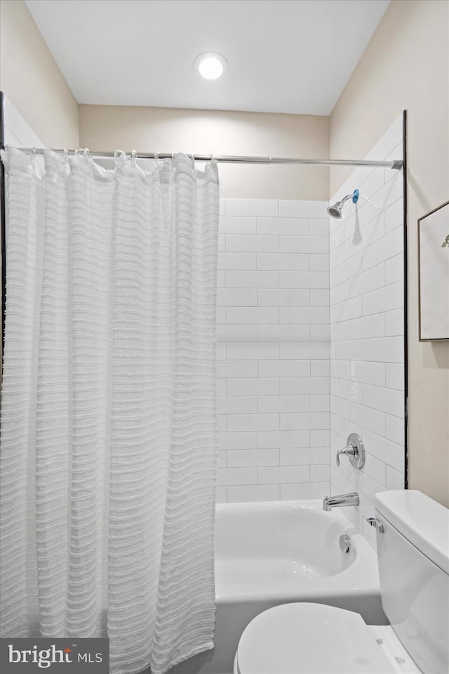 bathroom with toilet and shower / tub combo