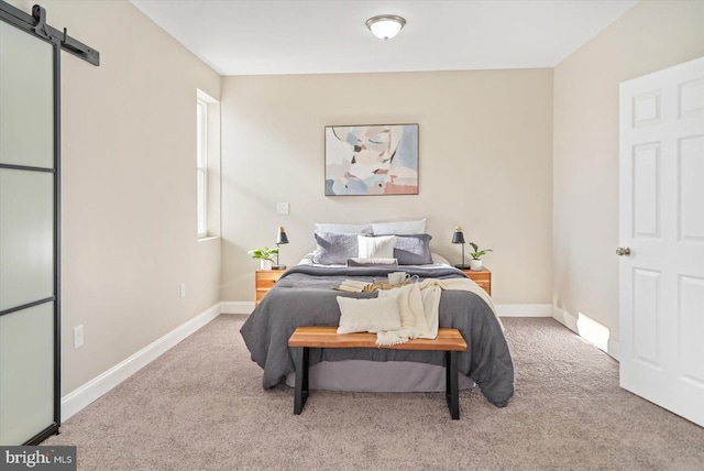 carpeted bedroom with a barn door