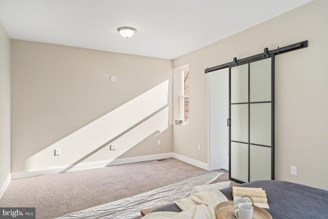 carpeted bedroom featuring a barn door