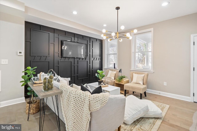 living room featuring a chandelier and light hardwood / wood-style flooring