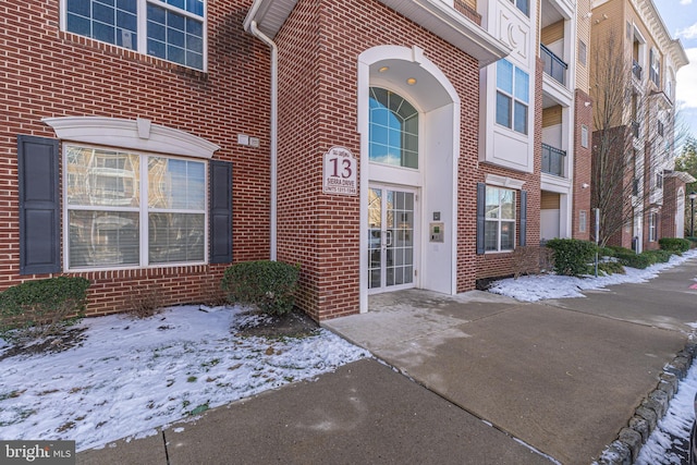 view of snow covered property entrance