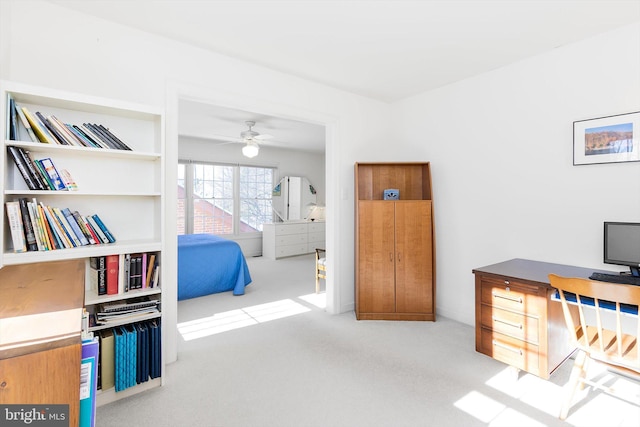 home office featuring light carpet and ceiling fan