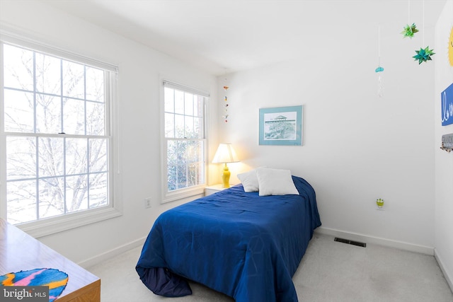 bedroom featuring light colored carpet