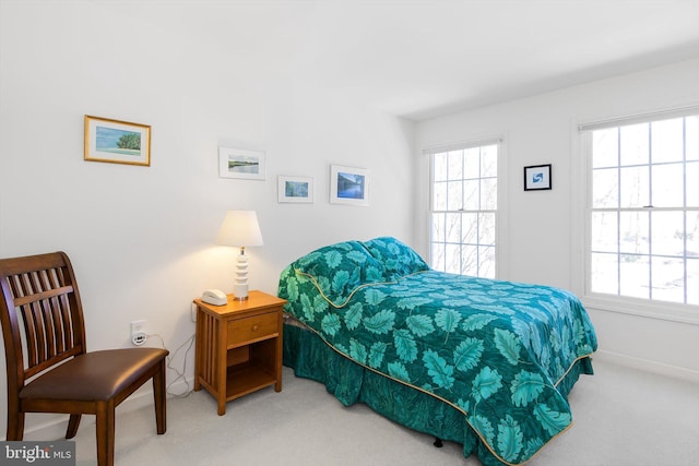 bedroom with multiple windows and carpet