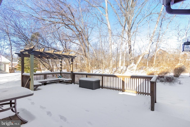 snow covered deck with a pergola