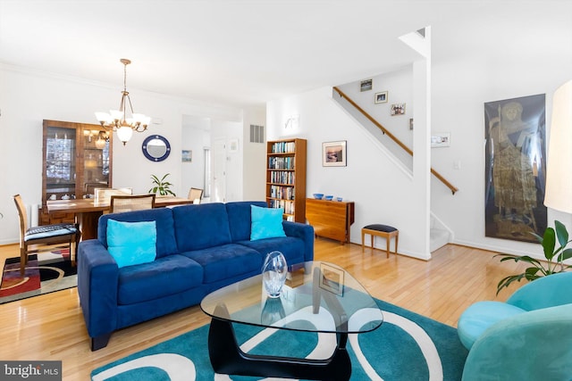 living room featuring light hardwood / wood-style flooring and a notable chandelier