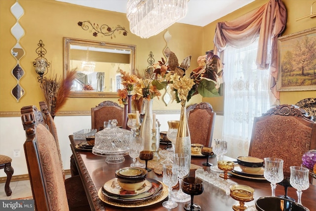 dining room with tile patterned flooring and an inviting chandelier