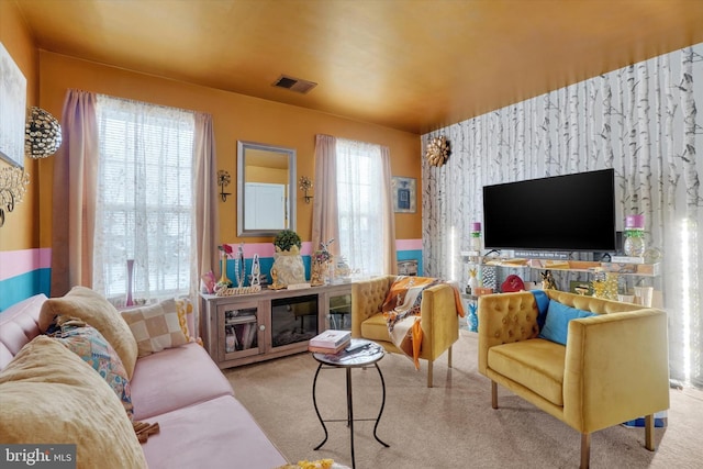 living room featuring light colored carpet and a wealth of natural light