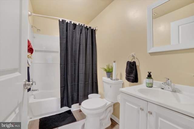 full bathroom featuring hardwood / wood-style floors, vanity, lofted ceiling, toilet, and shower / tub combo with curtain