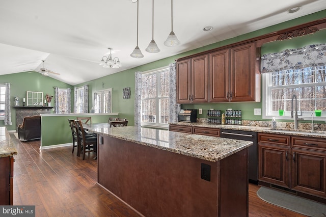 kitchen with hanging light fixtures, a center island, dark hardwood / wood-style flooring, sink, and stainless steel dishwasher