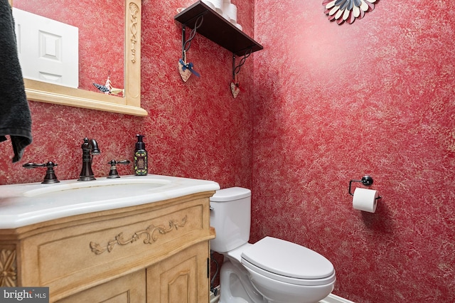 bathroom with toilet and vanity