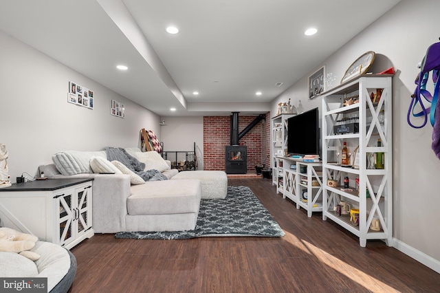 living room with a wood stove and dark hardwood / wood-style floors