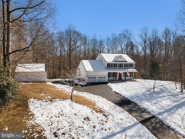 view of front of property featuring a garage and a porch