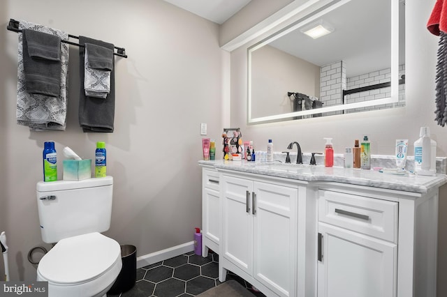 bathroom with tile patterned floors, vanity, and toilet