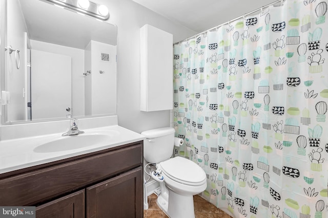 bathroom with tile patterned flooring, vanity, a shower with shower curtain, and toilet