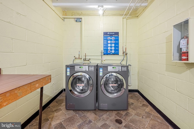 clothes washing area featuring independent washer and dryer