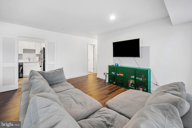 living room featuring dark hardwood / wood-style floors and sink