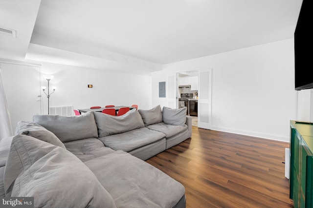 living room with dark hardwood / wood-style floors and electric panel