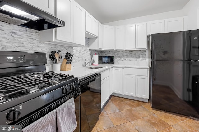 kitchen featuring black appliances, decorative backsplash, white cabinets, and sink