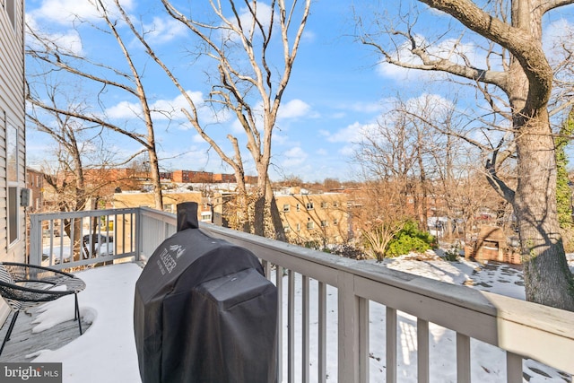 snow covered back of property featuring grilling area