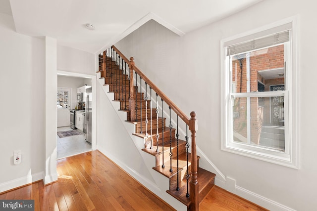 stairway with hardwood / wood-style flooring