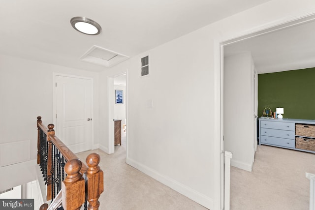 hallway with light colored carpet