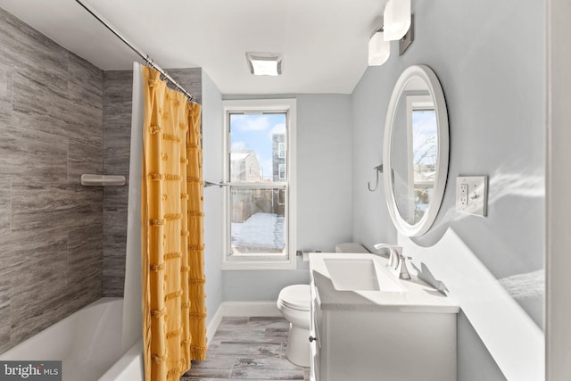 full bathroom featuring hardwood / wood-style flooring, shower / tub combo with curtain, vanity, and toilet