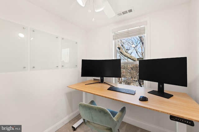 carpeted home office featuring ceiling fan