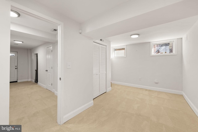 basement featuring light colored carpet