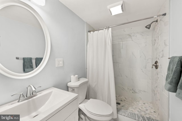 bathroom featuring walk in shower, vanity, and toilet