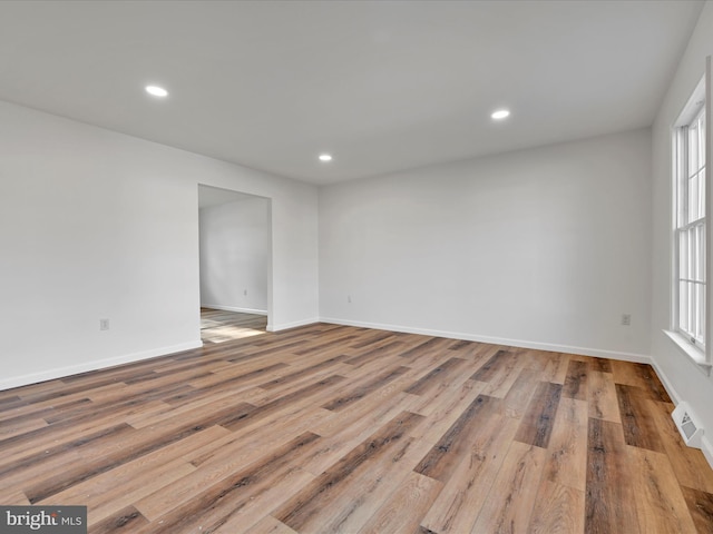 unfurnished room featuring a wealth of natural light and light hardwood / wood-style flooring