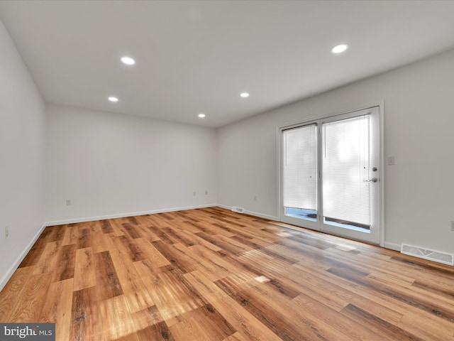 unfurnished room with light hardwood / wood-style flooring