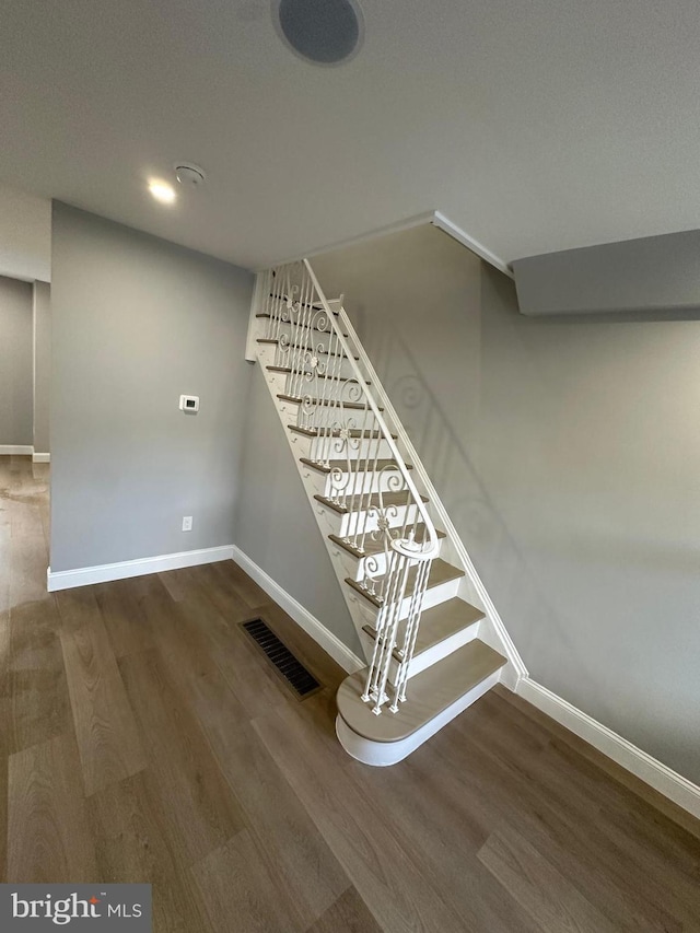 stairway with hardwood / wood-style floors